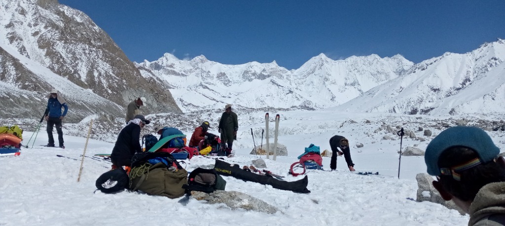 Camp gear being organized on snow in the high mountains
