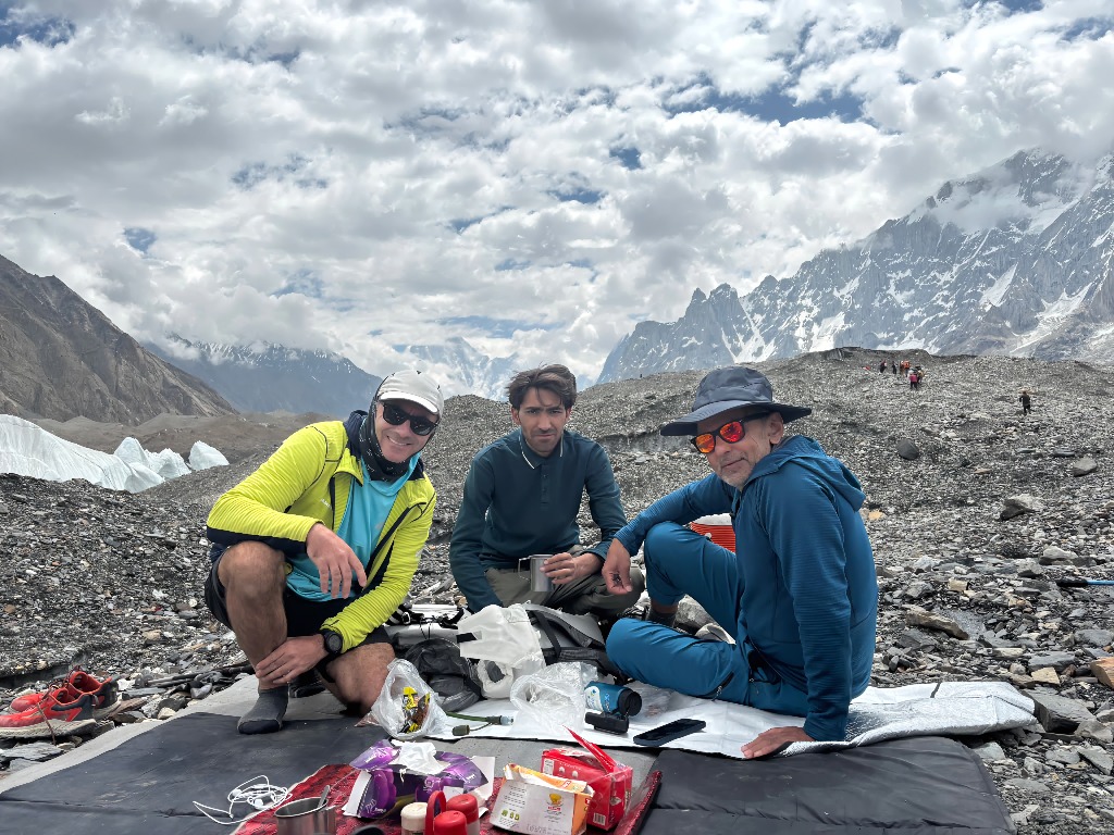 Expedition climbers and guides taking a rest break on the Baltoro Glacier